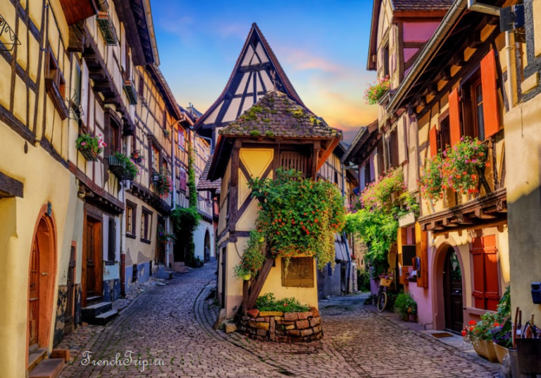Coloured half-timbered houses on a curving lane in Eguisheim