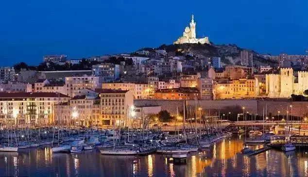 The Vieux-Port of Marseille at dusk with Notre-Dame de la Garde above