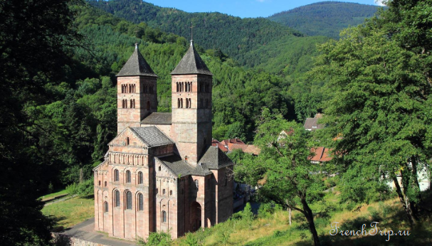 The Romanesque abbey church of Murbach in its wooded valley