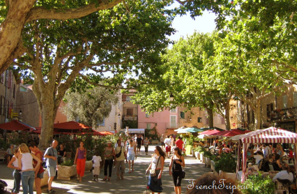 Café terraces under the elms on the main square of Tourtour