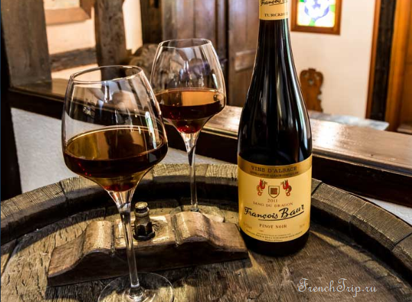 A tasting of Alsace wine on a barrel in a cellar