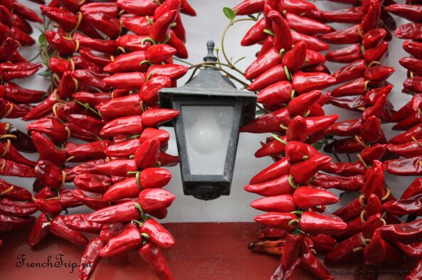 Strings of Espelette peppers drying on a Basque house