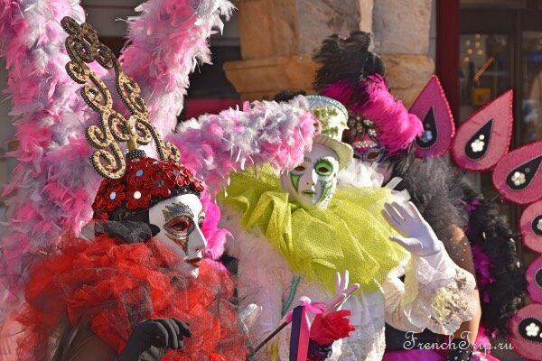 Masked fecos parading through the arcaded square of Limoux