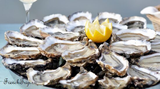 A plate of French oysters served on ice with lemon